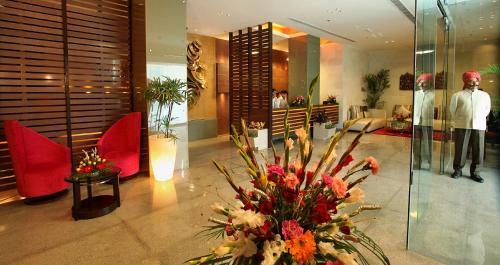 a lobby with a bouquet of flowers in the lobby at Ramada Ajmer in Kishangarh