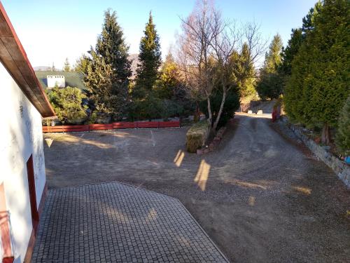 an empty parking lot with trees and a fence at Dom Wschodzącego Słońca in Solina