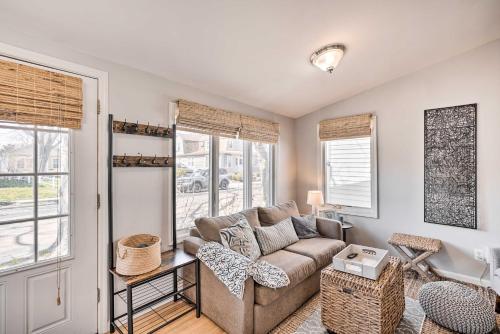 a living room with a couch and two windows at Bright Belmar Cottage Less Than Half Mi to Boardwalk! in Belmar