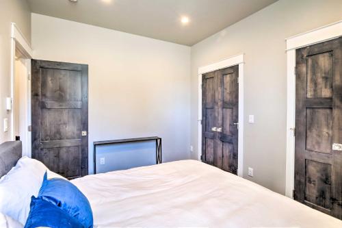 a bedroom with two wooden doors and a bed at Alma Retreat with Mtn Views about 17 Mi to Breck! in Alma