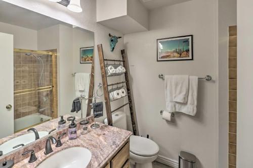 a bathroom with a sink and a toilet at Bullhead City Condo with Direct River Access! in Bullhead City
