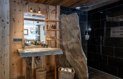a bathroom with a sink and a mirror at mama thresl in Leogang