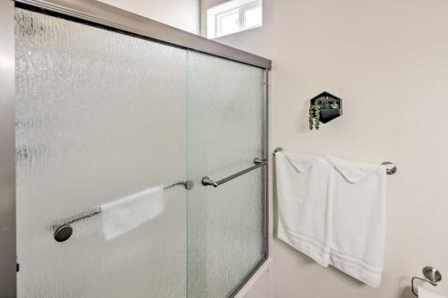 a shower with a glass door in a bathroom at Bright Home with Yard, 4 Mi to Colorado River! in Fort Mohave