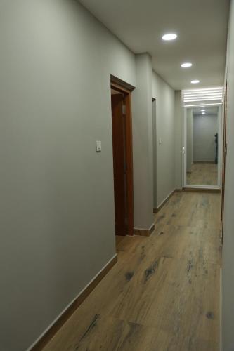 an empty hallway of an office with wood floors at Grace Apart Hotel @Kochi in Cochin