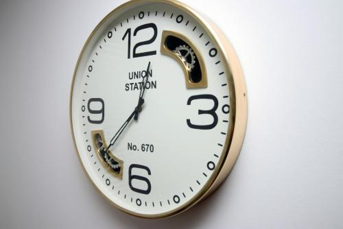 a clock that is on a wall at Bath Luxury City Centre 4 Bedroom Townhouse, Sleeps 8, Easy Parking, Private Courtyard Garden, by EMPOWER HOMES in Bath