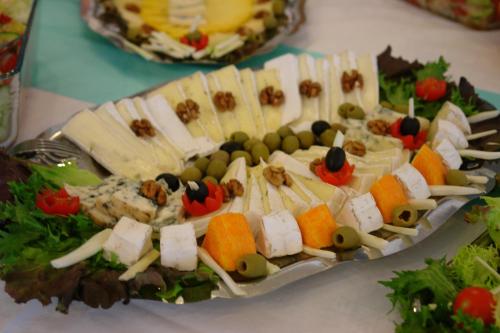 a platter of cheese and other foods on a table at Koller Panzió in Bonyhád