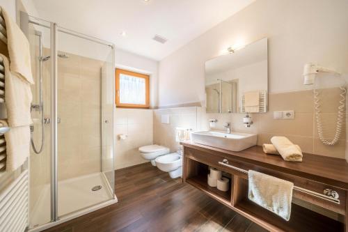 a bathroom with a sink and a toilet and a shower at Fewo Sonnenuntergang - Zeppichl in Pfelders