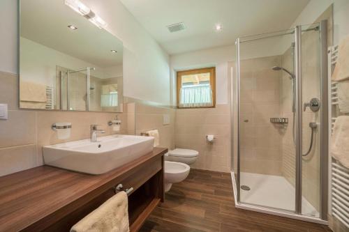 a bathroom with a sink and a toilet and a shower at Fewo Sonnenaufgang - Zeppichl in Pfelders