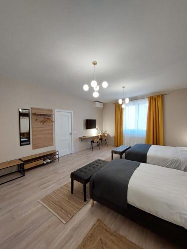 a hotel room with two beds and a television at Mandarin Premium Apartments in Târgu-Mureş