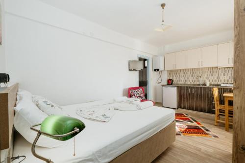 a bedroom with a bed with a green chair on it at Azra Apart & Otel in Gokceada Town