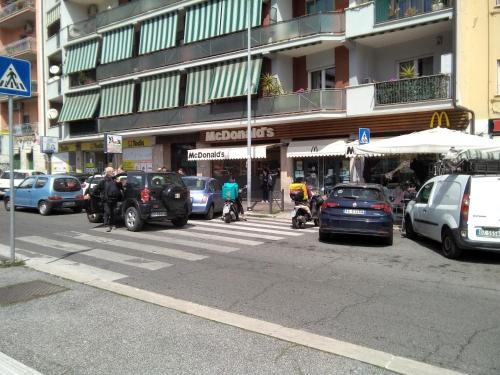 a busy city street with cars parked in front of a building at La Casa di Ludovica all'Appio Latino in Rome