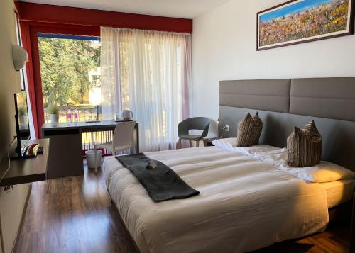 Ліжко або ліжка в номері Hotel Serpiano