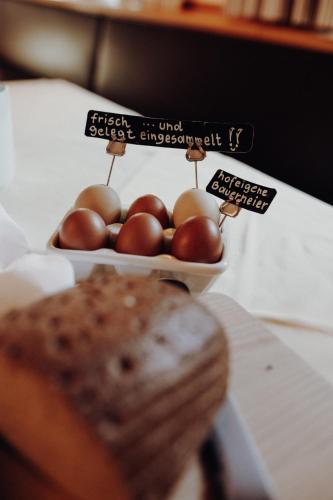 a bowl of eggs and a pastry on a table at Langwies Genussherberge in Hallein