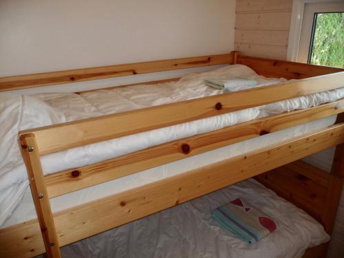 a wooden bunk bed in a tiny house at Séjour à la campagne pour 6 in Commequiers