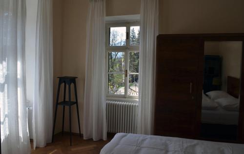 um quarto com uma cama e uma janela em Villa Iolanda em Merano