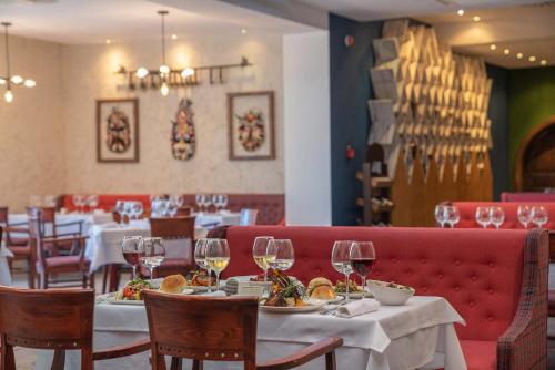 a dining room with tables and chairs and wine glasses at Sentido Marea Hotel - 24 hours Ultra All inclusive & Private Beach in Golden Sands