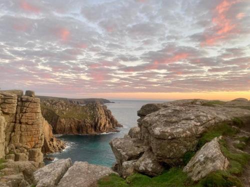 a view of the ocean from a rocky cliff at 2 Bedroom Cottage sleeps 4, with Pool Use, Sennen in Sennen