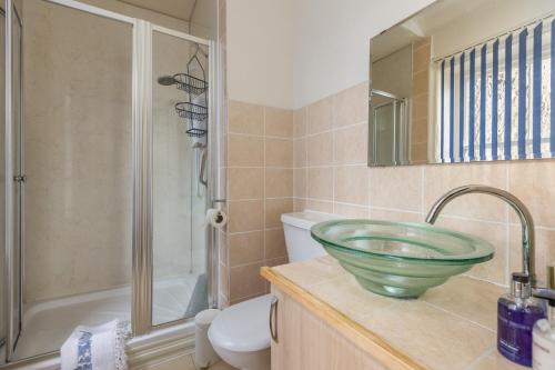 a bathroom with a sink and a shower and a toilet at Crossways in Pickering