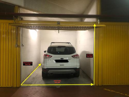 un'auto bianca è parcheggiata in un garage di Santa Chiara Apartment a Torino