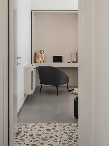 a living room with a chair and a table at Living u HomeSuites in Lecce