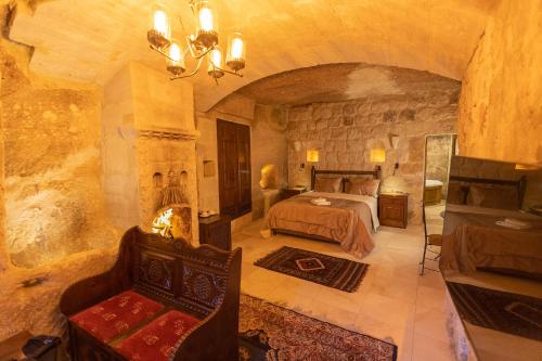 a large bedroom with a bed and a fireplace at Taskonak Hotel in Göreme