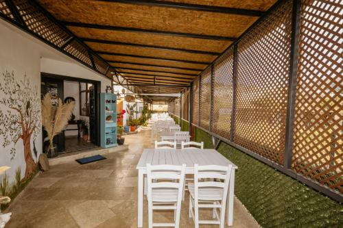 a table and chairs in a room with a wall at Azra Apart & Otel in Gokceada Town