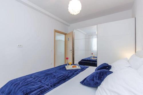 a bedroom with a large bed with blue pillows at House Lavander in Šmrika