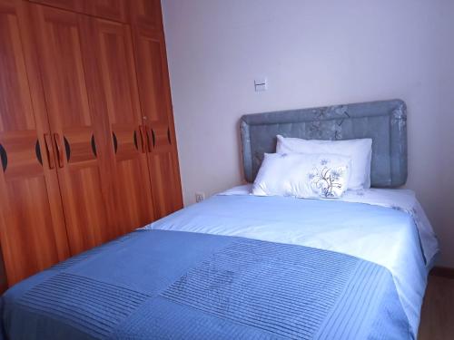 Un pat sau paturi într-o cameră la Casa Tranquilla - JKIA