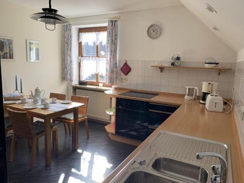 a kitchen with a table and a dining room at Ferienwohnung Agnes Mayer in Riedenburg