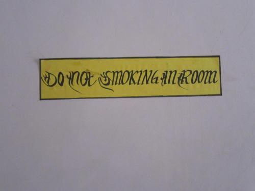 a sign that says do not shoot me in the room at STUPA VIEW INN in Kathmandu