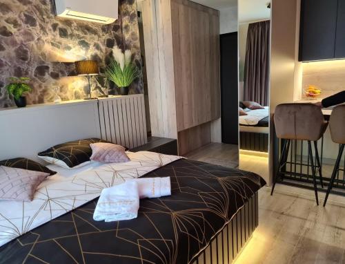 a hotel room with two beds and a bar at Wellness Apartments in Varaždin
