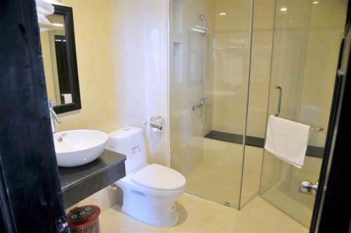 a bathroom with a toilet and a sink and a shower at Central Ly Son in Ly Son