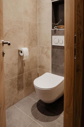 a bathroom with a toilet and a roll of toilet paper at Ferienhaus Bergler Hoamat in Navis