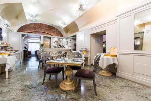 a dining room with a table and chairs at Hotel Art Atelier in Florence