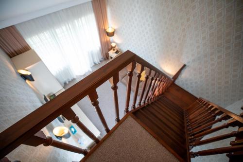 a wooden staircase with a window in a room at RIVER INN RESORT AND SPA in Nabran