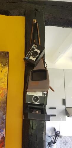 a camera is hanging on a wall at La petite maison in Le Bosc-Roger-en-Roumois