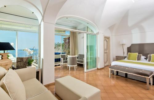 ein Schlafzimmer mit einem Bett und ein Wohnzimmer in der Unterkunft Hotel L'Ancora in Positano