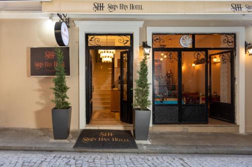 a store front with two potted plants in front of it at Sirin Han Hotel Old City in Istanbul