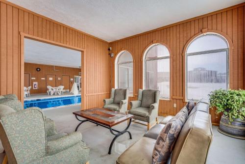 a living room with a couch and chairs and a pool at Quality Inn Hastings in Hastings