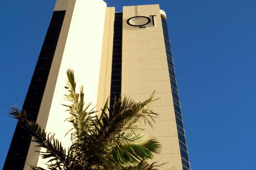 a tall building with a clock on top of it at QT Gold Coast in Gold Coast
