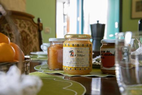 a table with jars of honey on a table at Agriturismo Petrara in Simeri