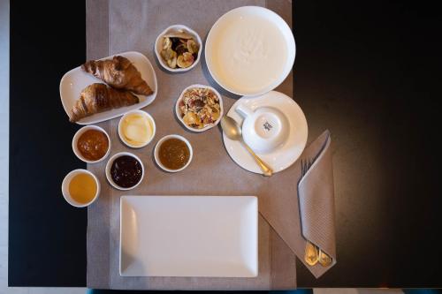 a table topped with plates and bowls of food at Relais Forte Benedek Wine & SPA - Adults Only in Pastrengo