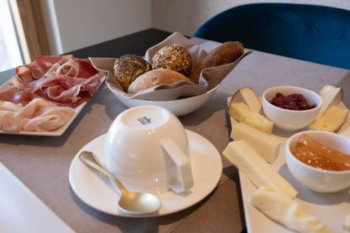 a table topped with plates and bowls of different types of food at Relais Forte Benedek Wine & SPA - Adults Only in Pastrengo