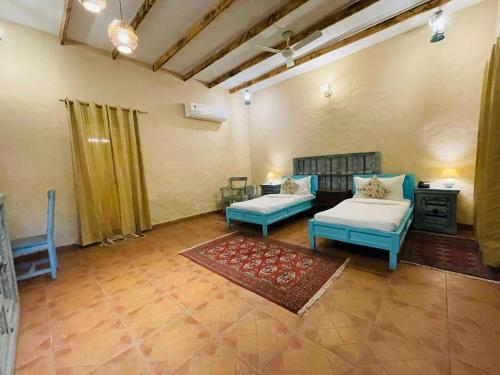a living room with two couches and a table at WelcomHeritage Ranjitvilas in Amritsar