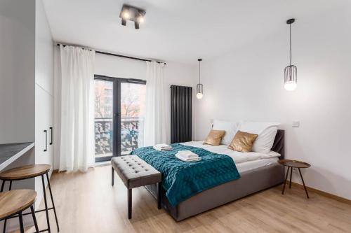 a bedroom with a bed and a table and chairs at Rent like home - Dwie Motławy in Gdańsk