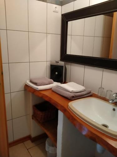a bathroom with a sink and a mirror at Au coeur du Caylar in Le Caylar