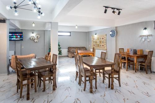 a dining room with wooden tables and chairs at Snow Time Eco Chalet in Gudauri