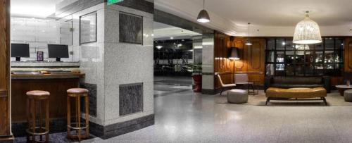 a lobby with a bar and stools in a building at Wyndham Garden Santiago Kennedy in Santiago