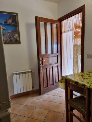a door to a room with a table and a table and a tableablish at Appartamenti Quilici in Santa Maria Navarrese