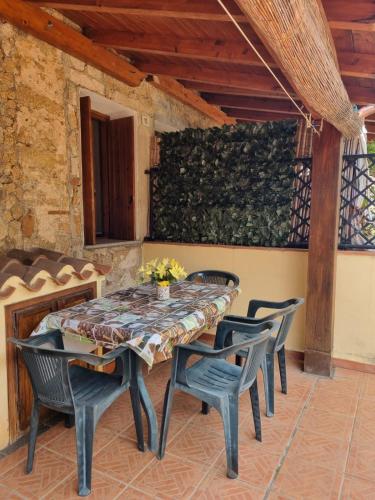 a table and chairs on a patio at Appartamenti Quilici in Santa Maria Navarrese
